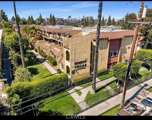 an aerial view of a residential apartment building with a yard