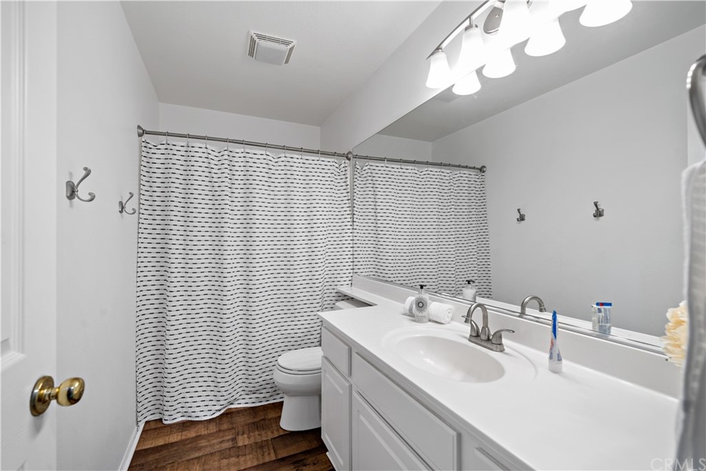 36661 Beech Street Winchester, CA 92596 - Photo 23 of 33 a bathroom with a sink a toilet and shower curtain