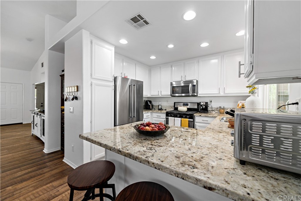 36661 Beech Street Winchester, CA 92596 - Photo 7 of 33 a kitchen with stainless steel appliances granite countertop a refrigerator and a stove