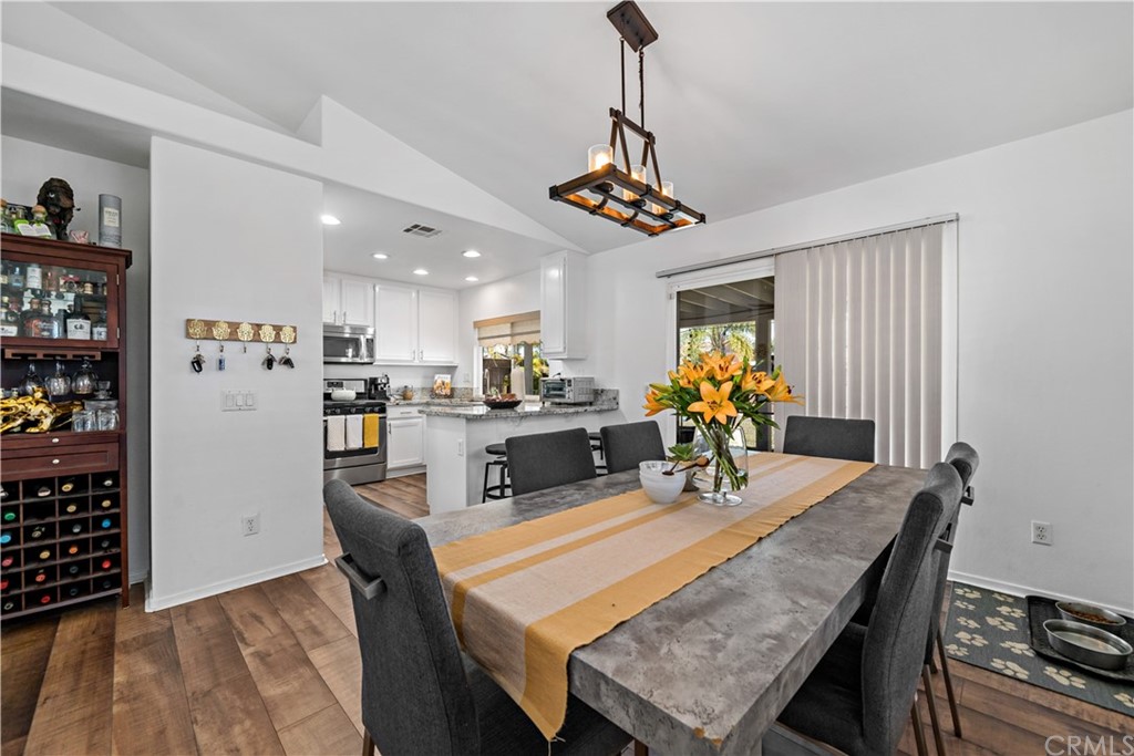 36661 Beech Street Winchester, CA 92596 - Photo 10 of 33 a view of a dining room and livingroom with furniture wooden floor a chandelier