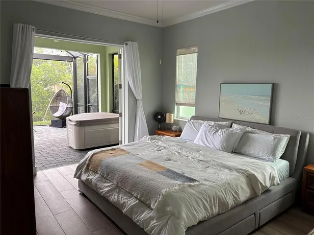 a bedroom with a large bed and a large window