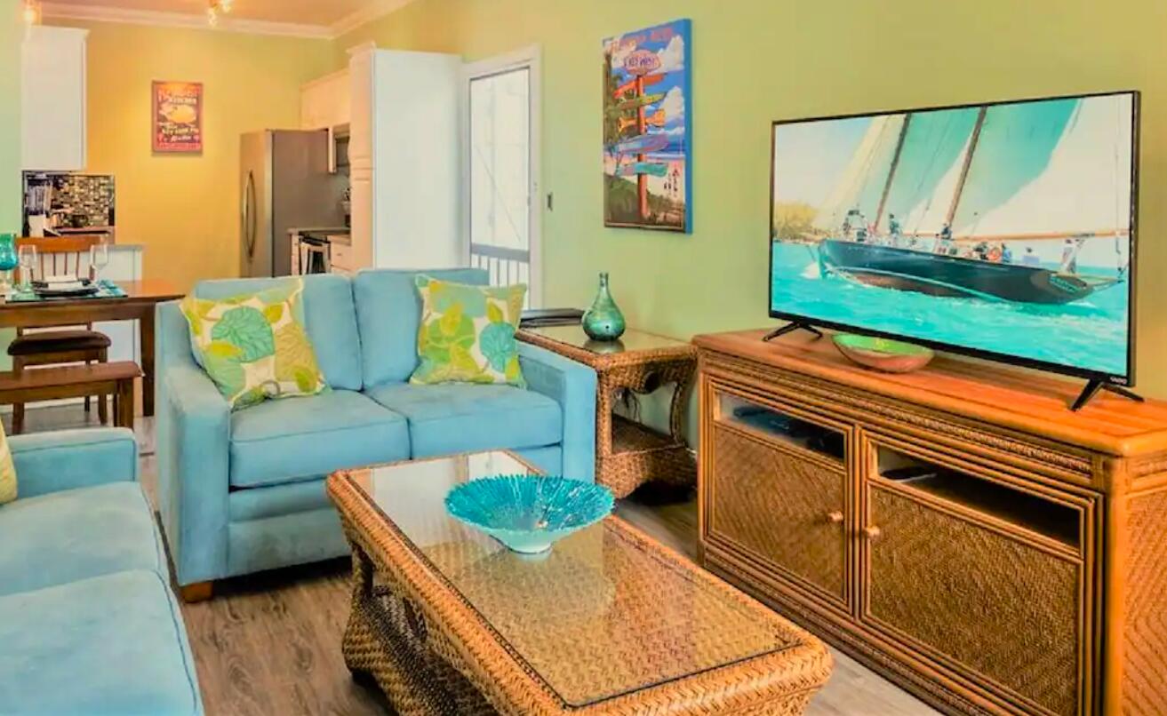906 Truman Avenue, Unit 1 Key West, FL 33040 - Photo 3 of 12 a living room with furniture and a flat screen tv