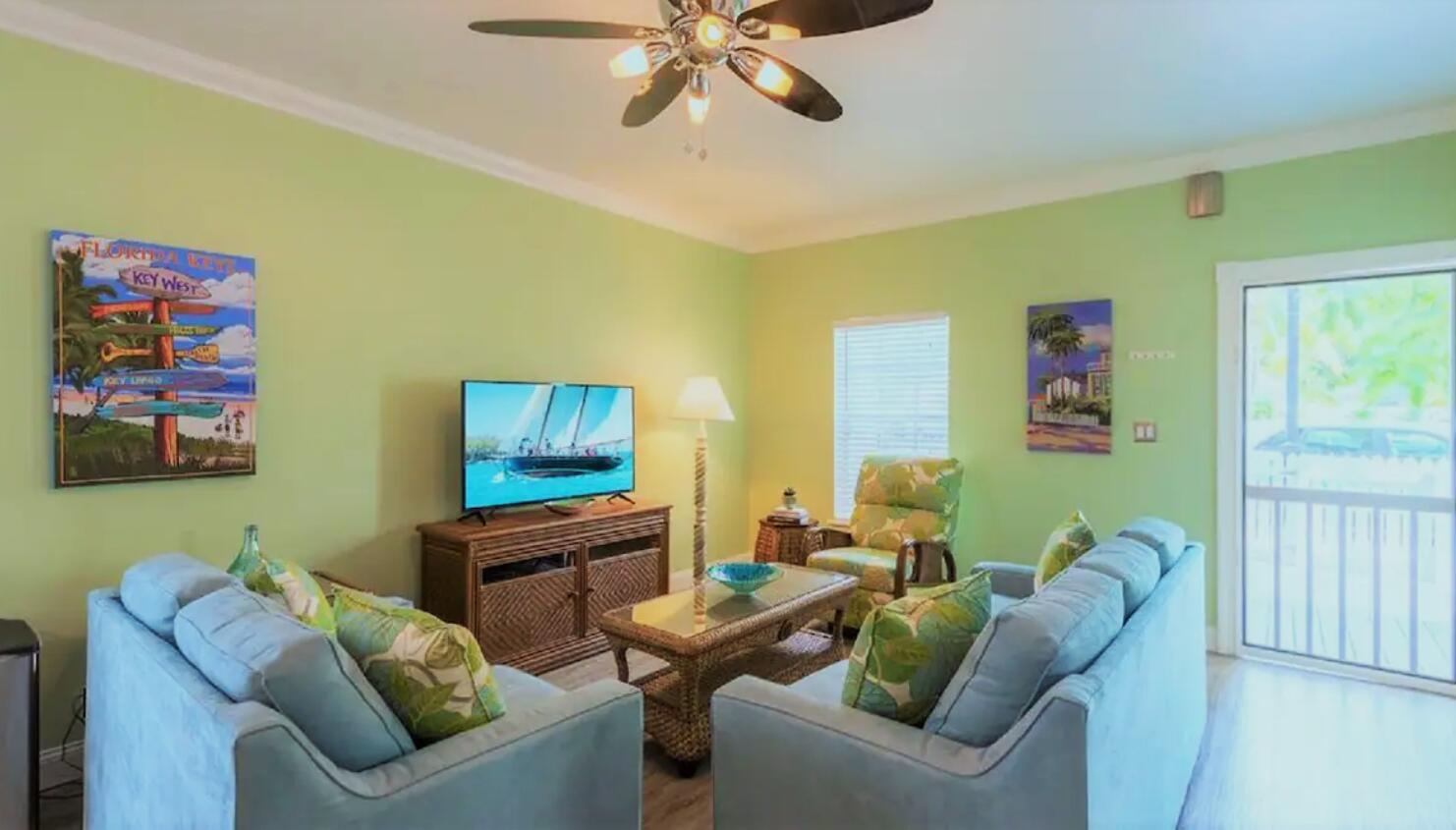 906 Truman Avenue, Unit 1 Key West, FL 33040 - Photo 4 of 12 a living room with furniture and a flat screen tv