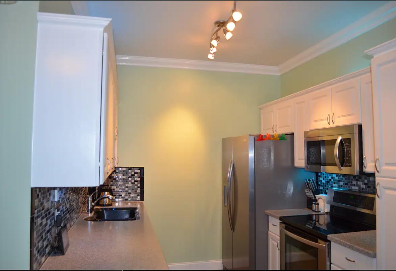 906 Truman Avenue, Unit 1 Key West, FL 33040 - Photo 6 of 12 a kitchen with stainless steel appliances granite countertop a refrigerator and a stove top oven