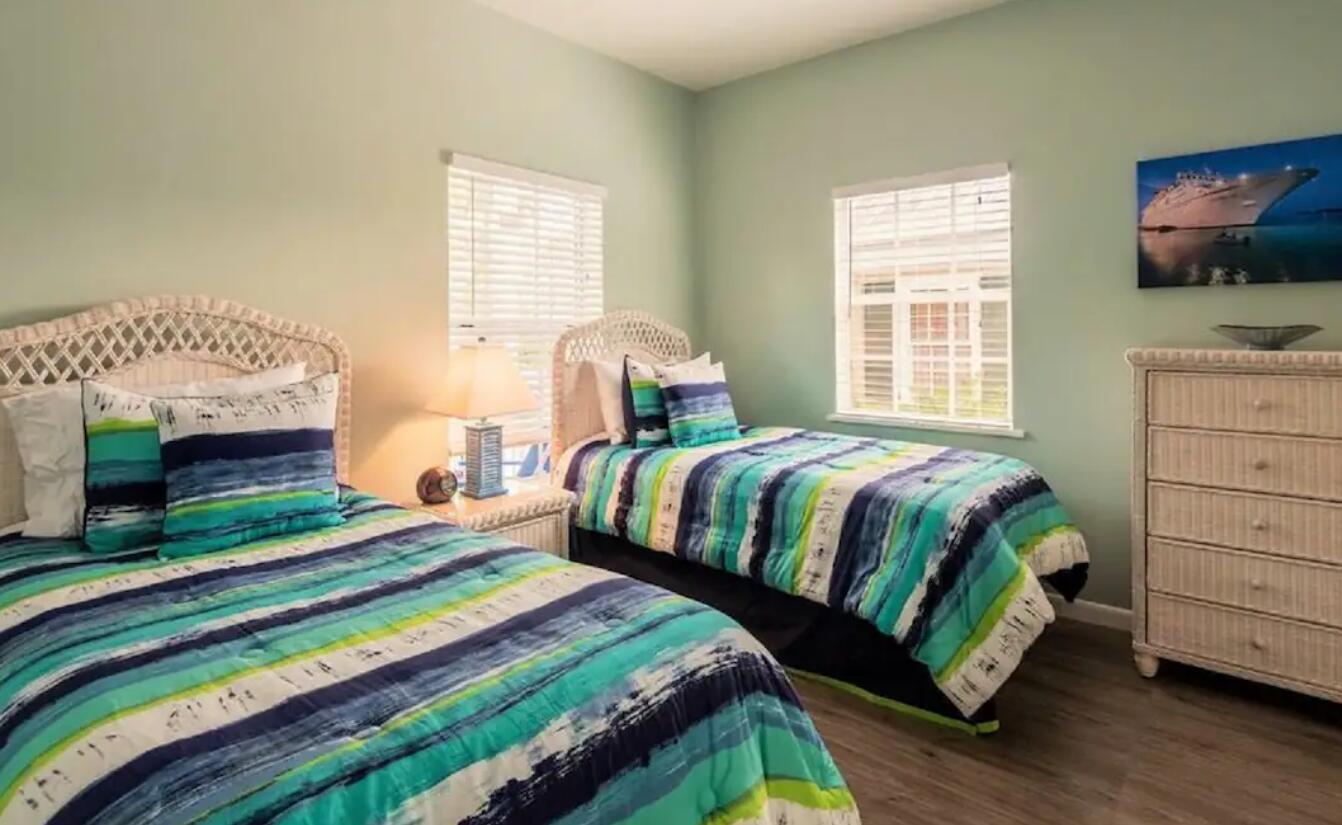 906 Truman Avenue, Unit 1 Key West, FL 33040 - Photo 9 of 12 a bedroom with a bed and a flat screen tv