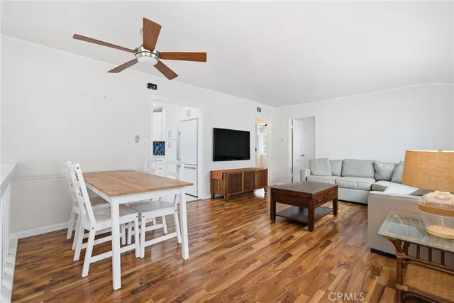 a living room with furniture a flat screen tv and a table