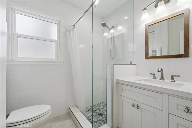 a bathroom with a toilet a sink a mirror a vanity and vanity