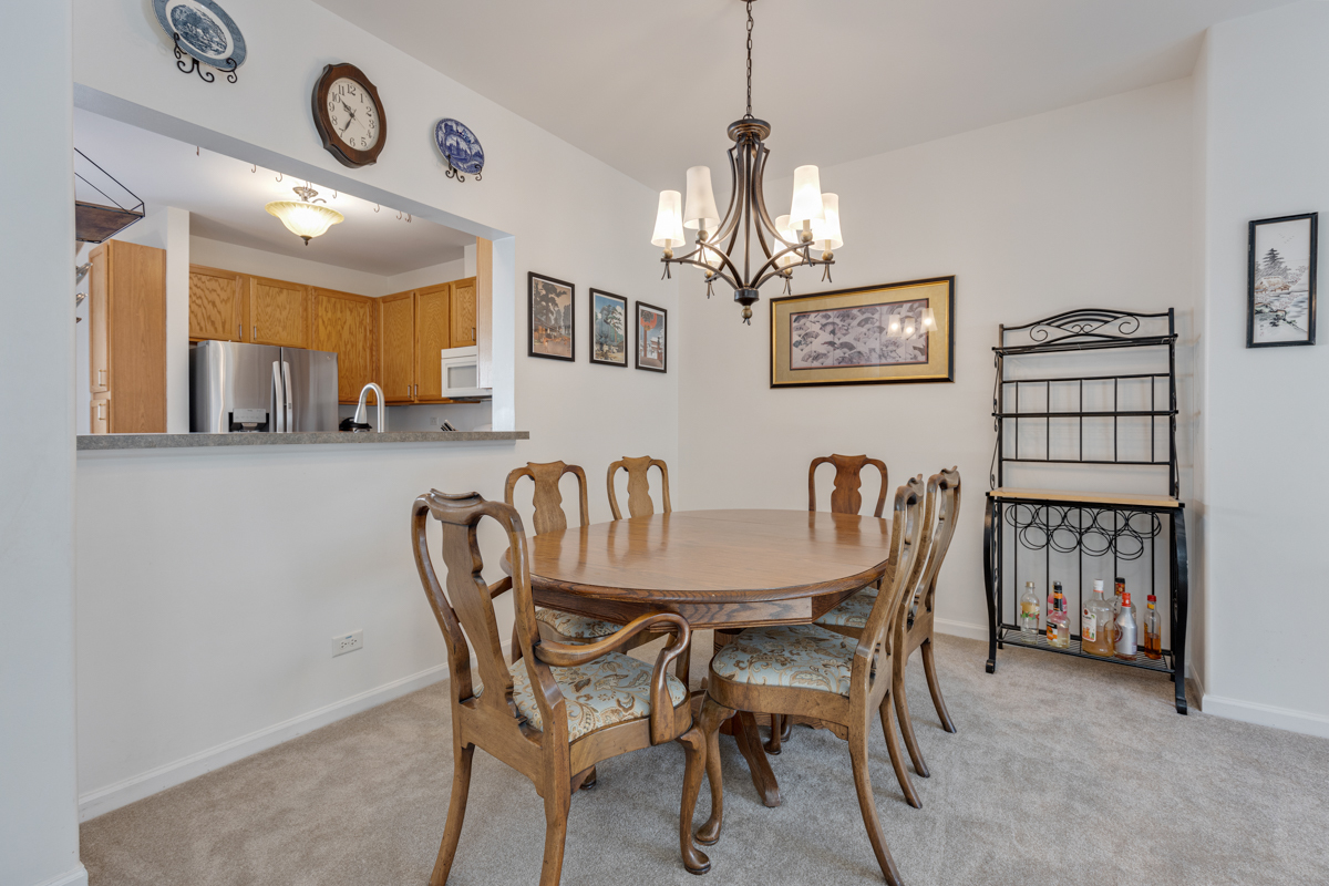 232 New Haven Drive Cary, IL 60013 - Photo 17 of 25 a view of a dining room with furniture a chandelier and a rug