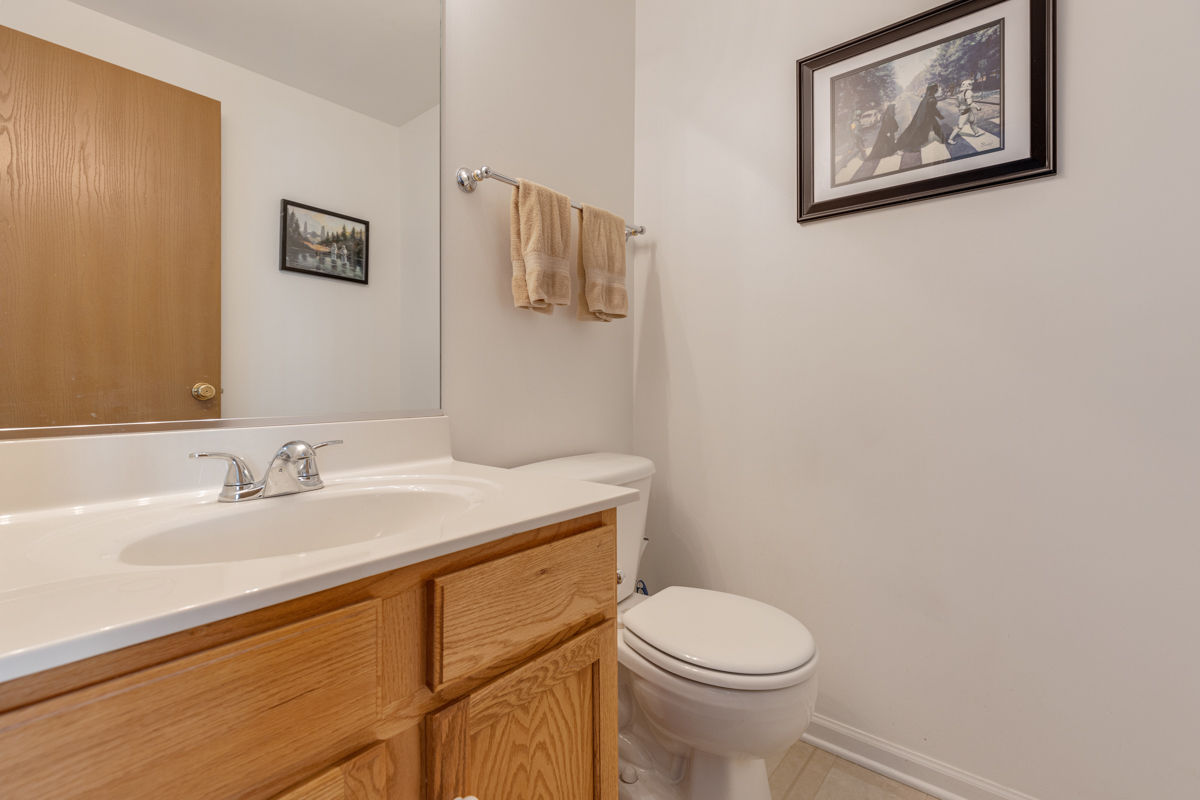 232 New Haven Drive Cary, IL 60013 - Photo 19 of 25 a bathroom with a granite countertop toilet a sink and mirror