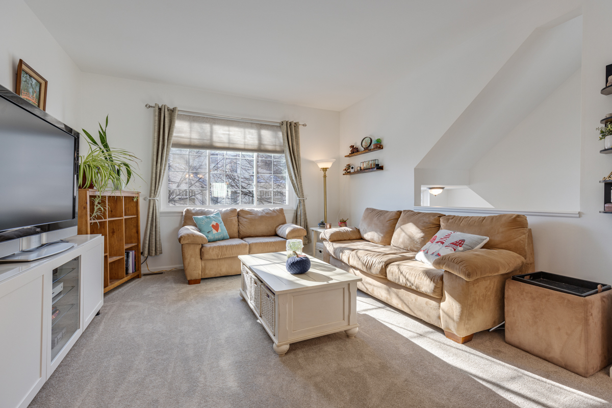 232 New Haven Drive Cary, IL 60013 - Photo 2 of 25 a living room with furniture a flat screen tv and a large window