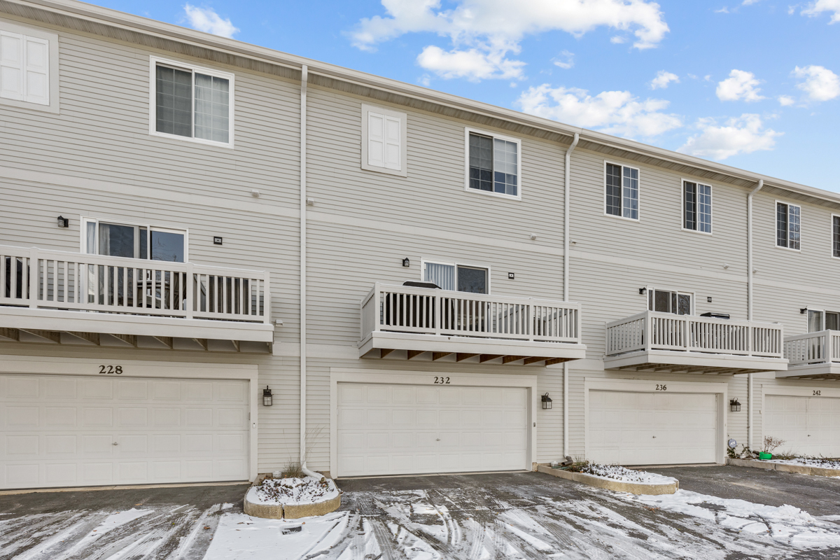232 New Haven Drive Cary, IL 60013 - Photo 21 of 25 a front view of a house with balcony