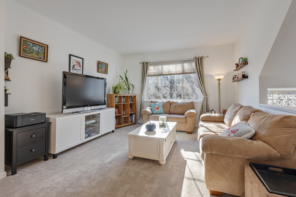 232 New Haven Drive Cary, IL 60013 - Photo 24 of 25 a living room with furniture and a flat screen tv