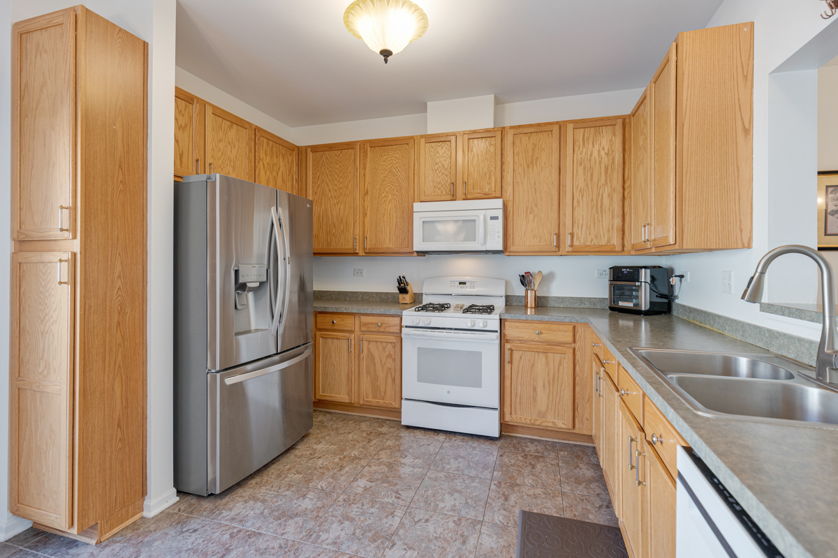 232 New Haven Drive Cary, IL 60013 - Photo 3 of 25 a kitchen with a refrigerator sink and cabinets