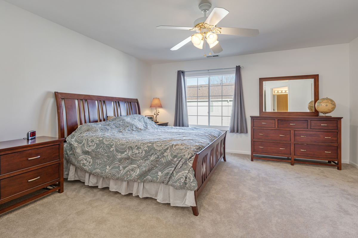 232 New Haven Drive Cary, IL 60013 - Photo 4 of 25 a bed room with a bed and a dresser
