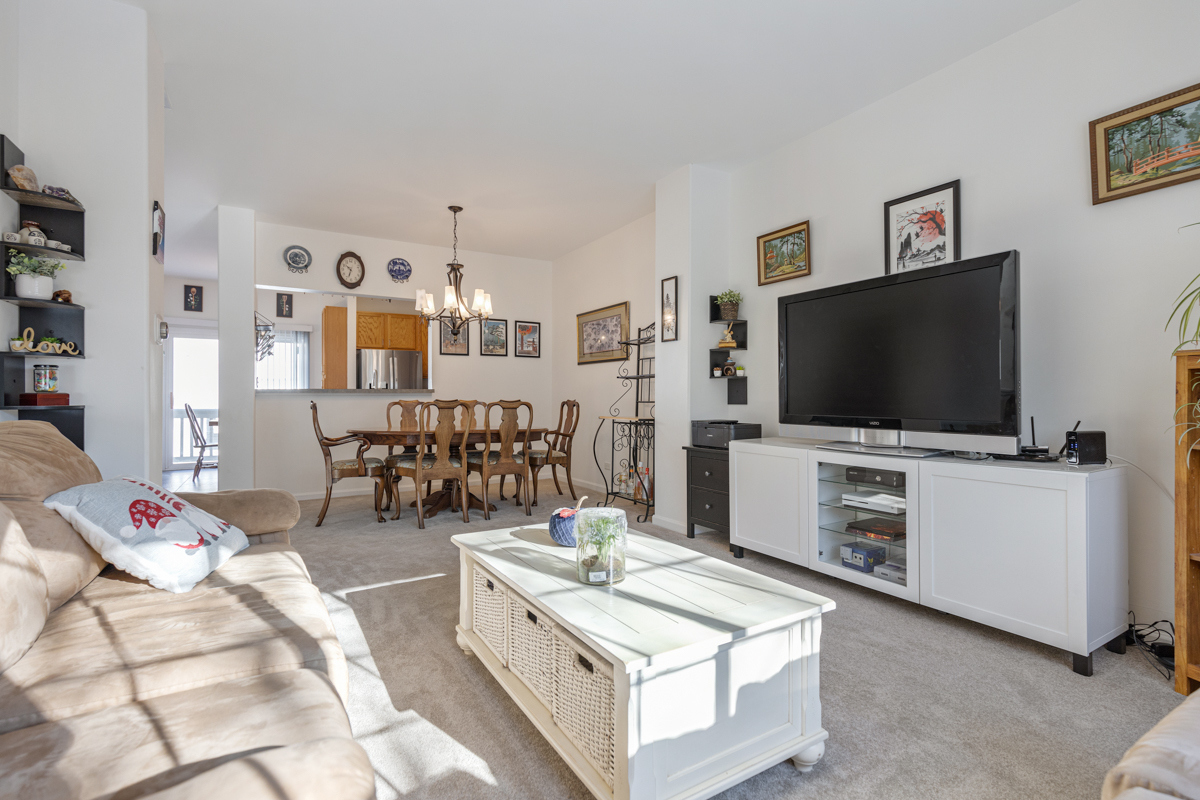 232 New Haven Drive Cary, IL 60013 - Photo 7 of 25 a living room with furniture and a flat screen tv