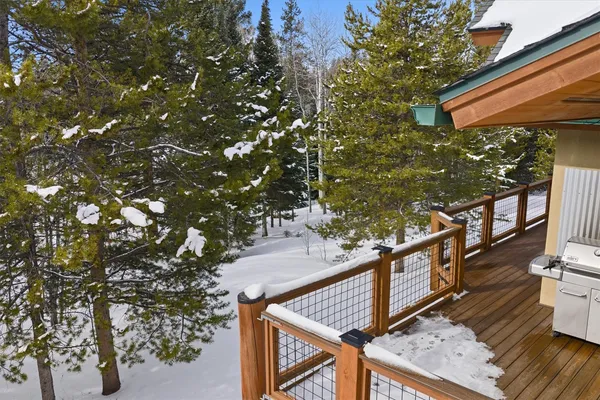 a view of balcony with wooden floor and fence