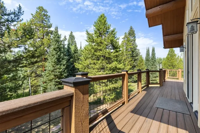 a view of balcony with wooden floor and fence