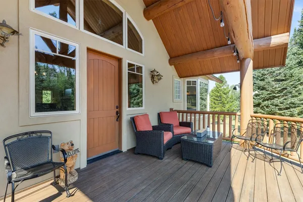 a balcony with furniture and wooden floor