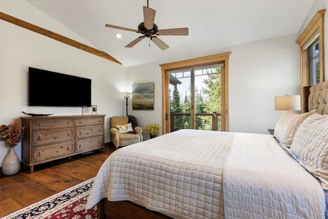 a bedroom with a bed and flat screen tv