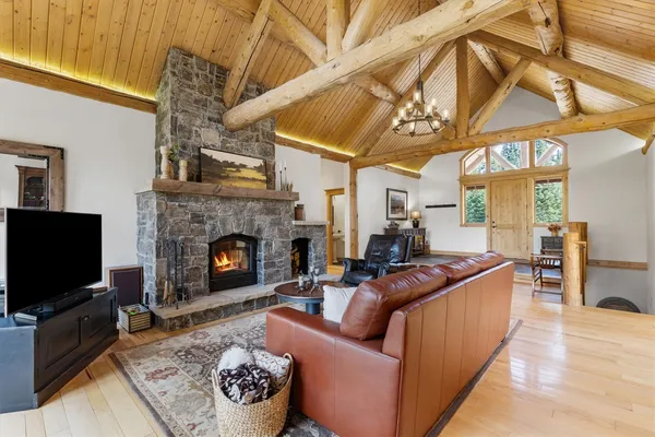 a living room with furniture a flat screen tv and a fireplace