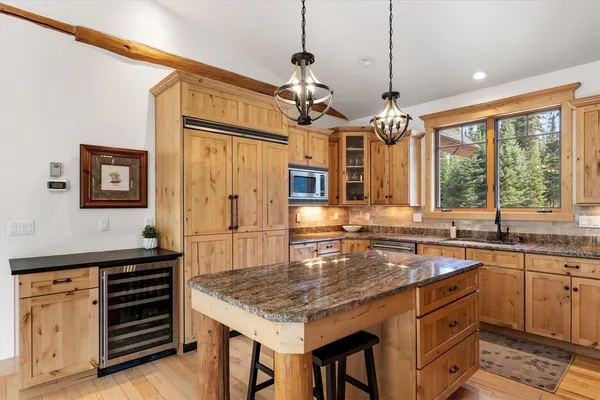 a kitchen with stainless steel appliances granite countertop a sink and a stove