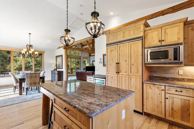 a kitchen with stainless steel appliances granite countertop a sink and microwave