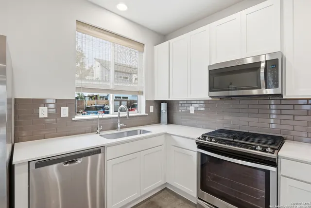 a kitchen with a sink and large window