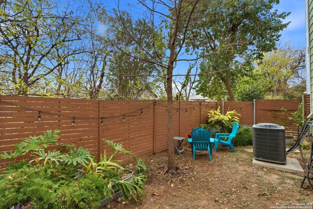 a view of a chairs and table in the back yard of the house