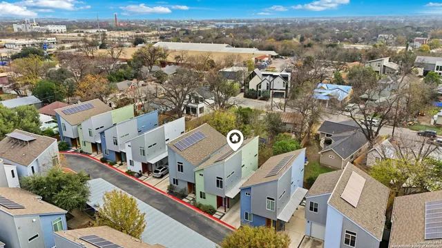 an aerial view of residential houses with outdoor space