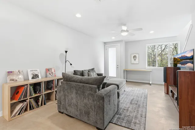 a kitchen with a dining table chairs wooden floor and appliances