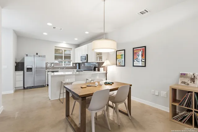a kitchen with granite countertop white cabinets and appliances