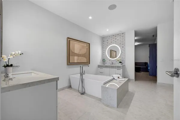 a view of a patio with table and chairs and potted plants