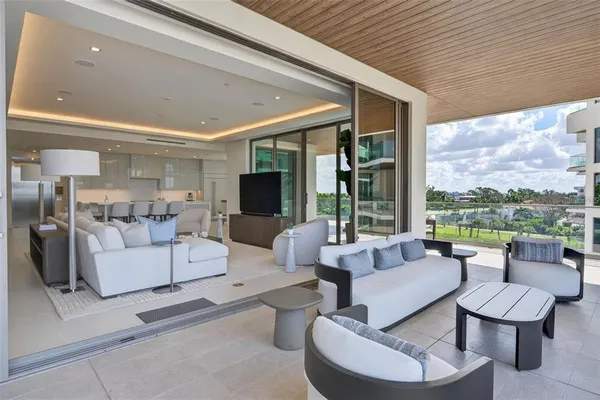 a bedroom with a large bed and a potted plant