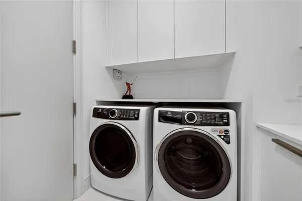 a view of a house with swimming pool and sitting area