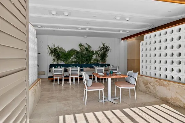 a view of a swimming pool with outdoor seating and a patio