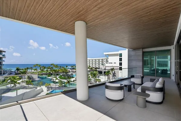 a view of a patio with table and chairs and potted plants