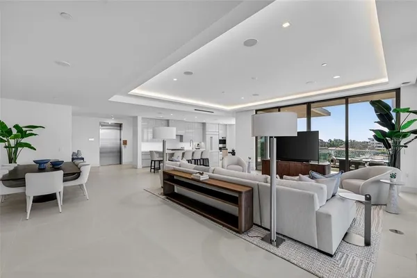 a bedroom with a large bed and large windows