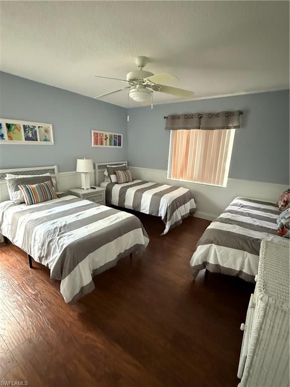 760 Augusta Boulevard, Unit D204 Naples, FL 34113 - Photo 32 of 32 a bedroom with two beds and a chandelier