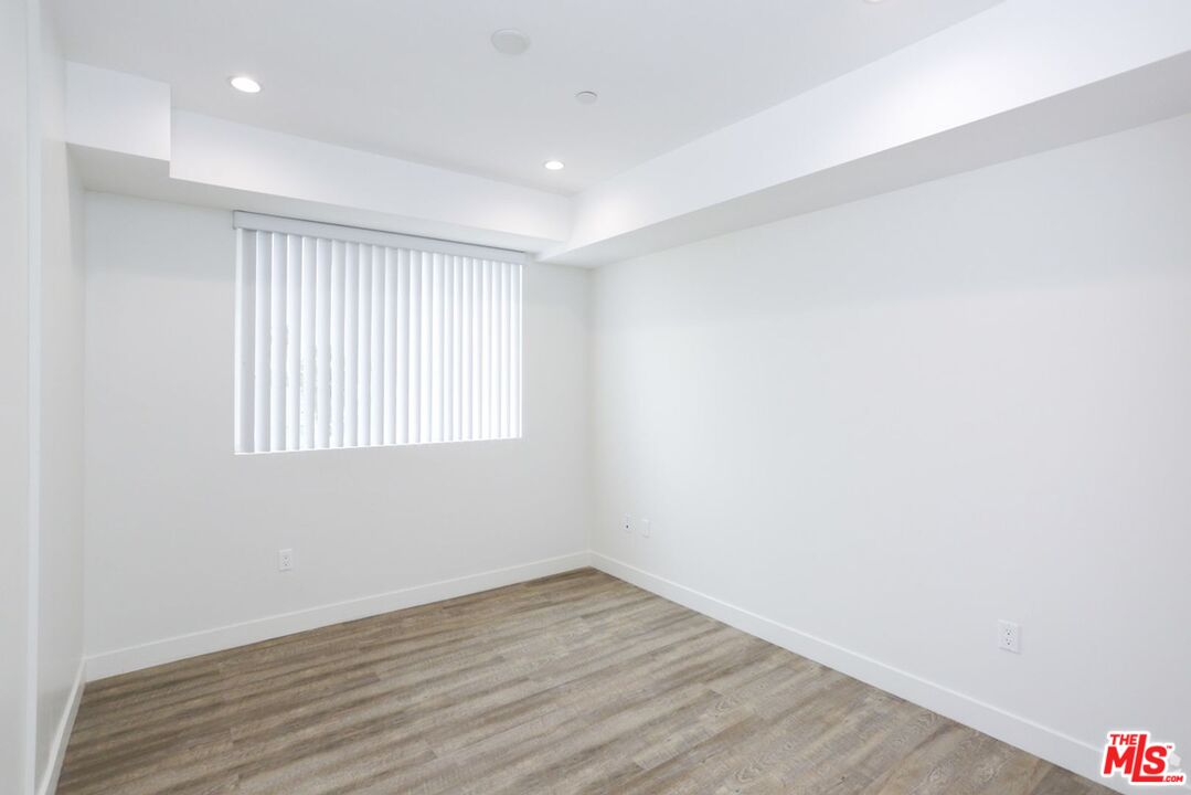 744 Hartford Avenue, Unit 206 Los Angeles, CA 90017 - Photo 11 of 23 a view of an empty room with wooden floor and a window