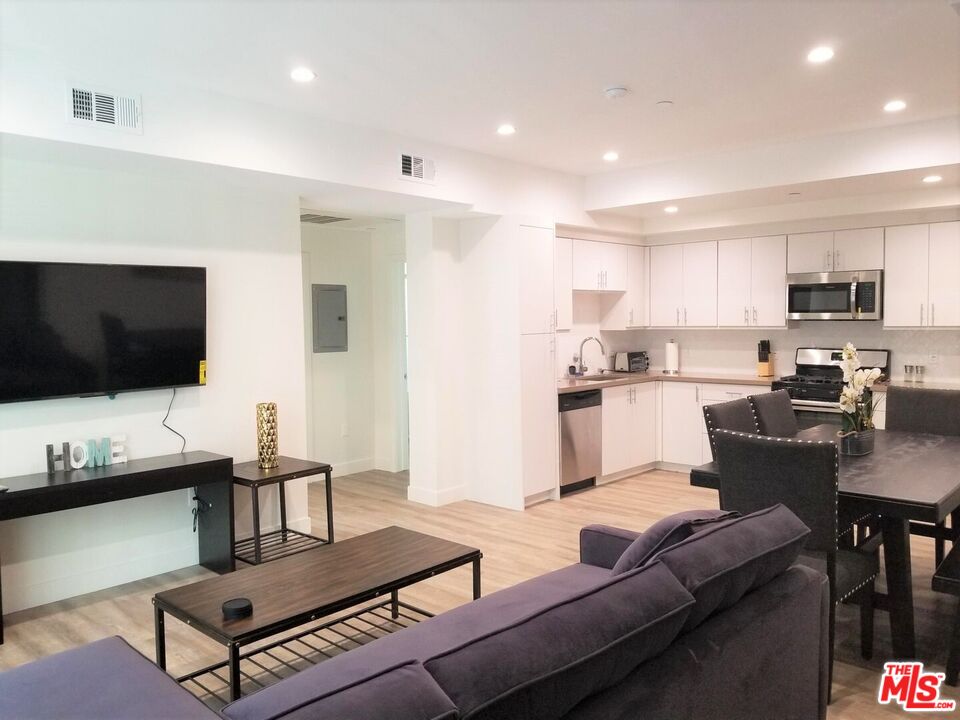 744 Hartford Avenue, Unit 206 Los Angeles, CA 90017 - Photo 7 of 23 a living room with furniture and a flat screen tv