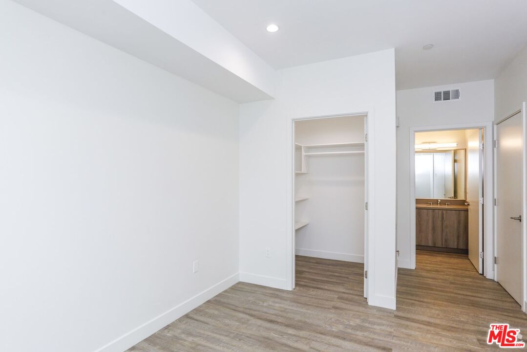 744 Hartford Avenue, Unit 206 Los Angeles, CA 90017 - Photo 8 of 23 a view of an empty room with wooden floor & closet