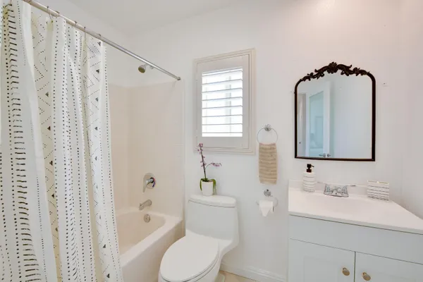 a bathroom with a sink toilet a shower and a mirror