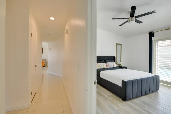 a bedroom with a bed and ceiling fan