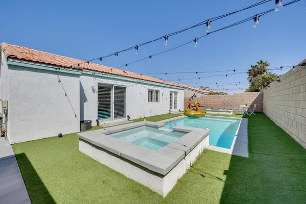 a view of a house with a backyard