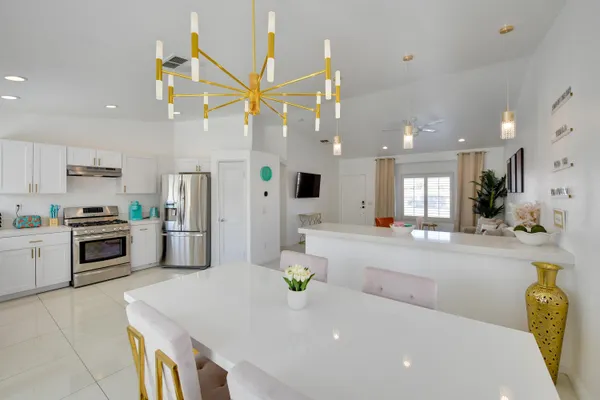 a kitchen with a sink a counter top space appliances and cabinets