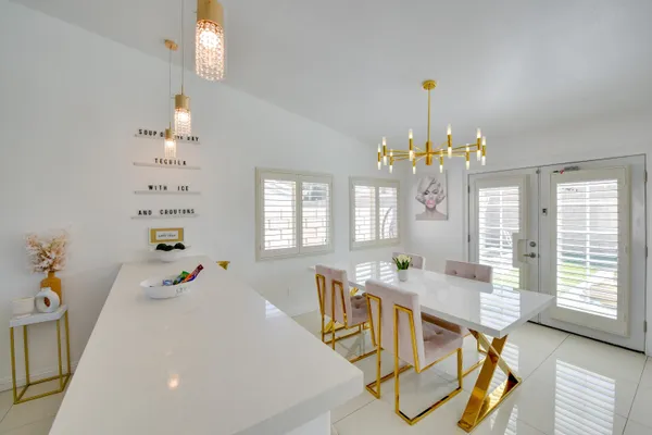 a view of a dining room with furniture and chandelier