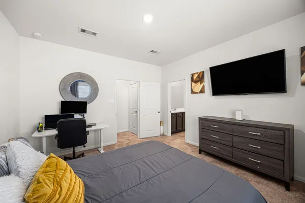 a bedroom with a bed and a flat screen tv
