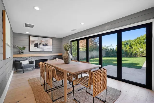 a view of a dining room with furniture large windows and wooden floor