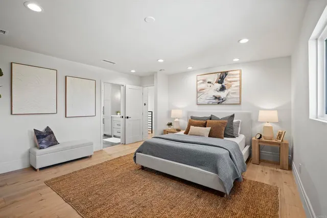 a spacious bedroom with a bed and a couch