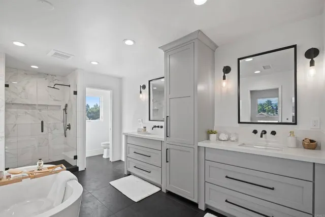 a bathroom with a double vanity sink mirror double and shower